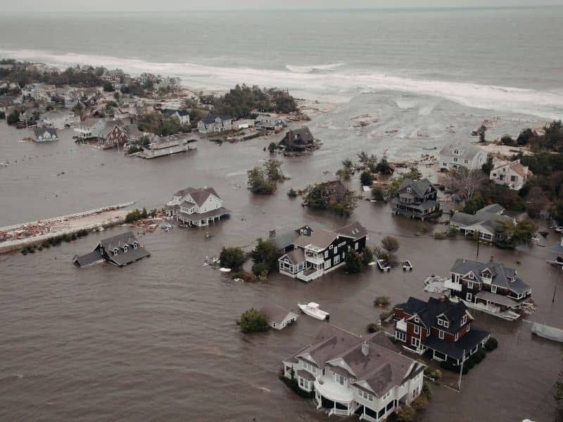 Drone view of a coastal residential neighborhood affected by tidal flooding and rising water levels